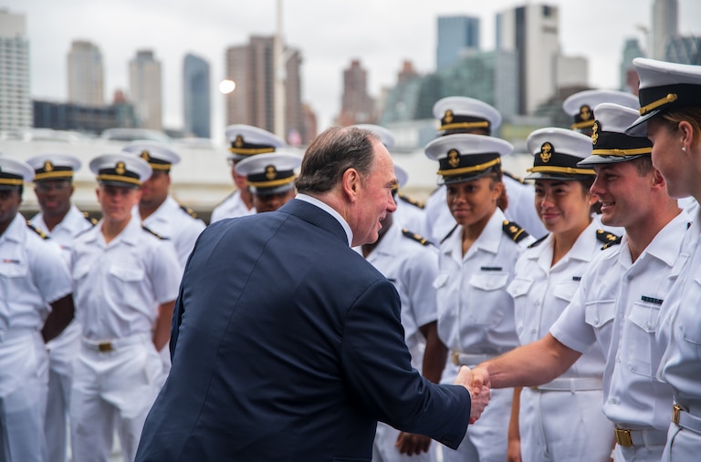 Secretary of the Navy John Phelan greets Naval Academy midshipmen during a tour of the USS New York during Fleet Week New York in May.