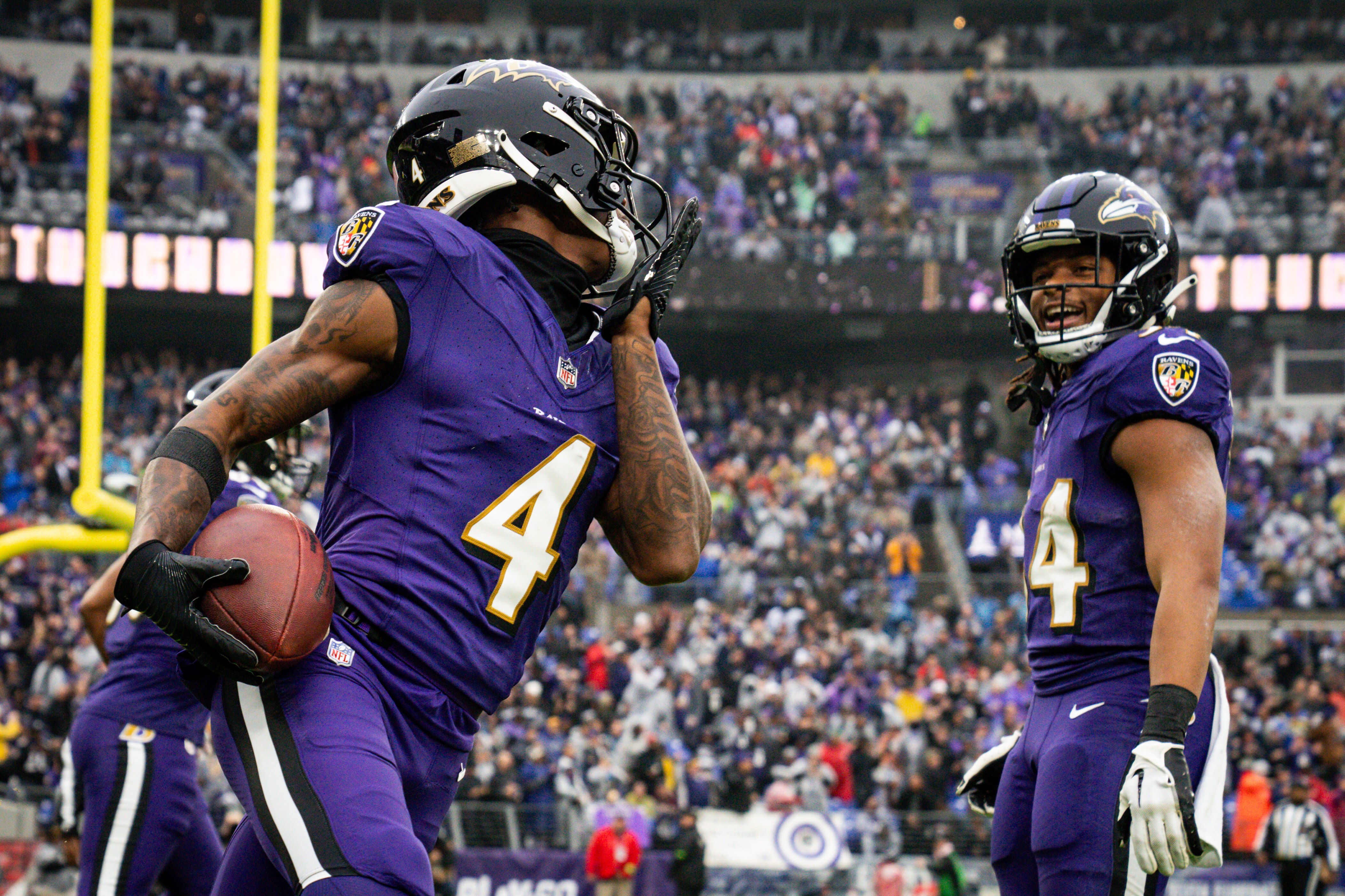 Baltimore Ravens wide receiver Zay Flowers (4) runs around the end zone in celebration after tight end Isaiah Likely (80) scored a touchdown during the first quarter against the Los Angeles Rams at M&T Bank Stadium on Sunday, Dec. 10, 2023.