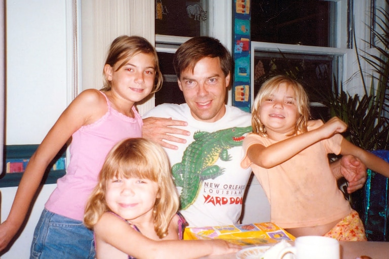 Tim Smith at home in West Towson with his daughters Christie, Julianna and Hope.