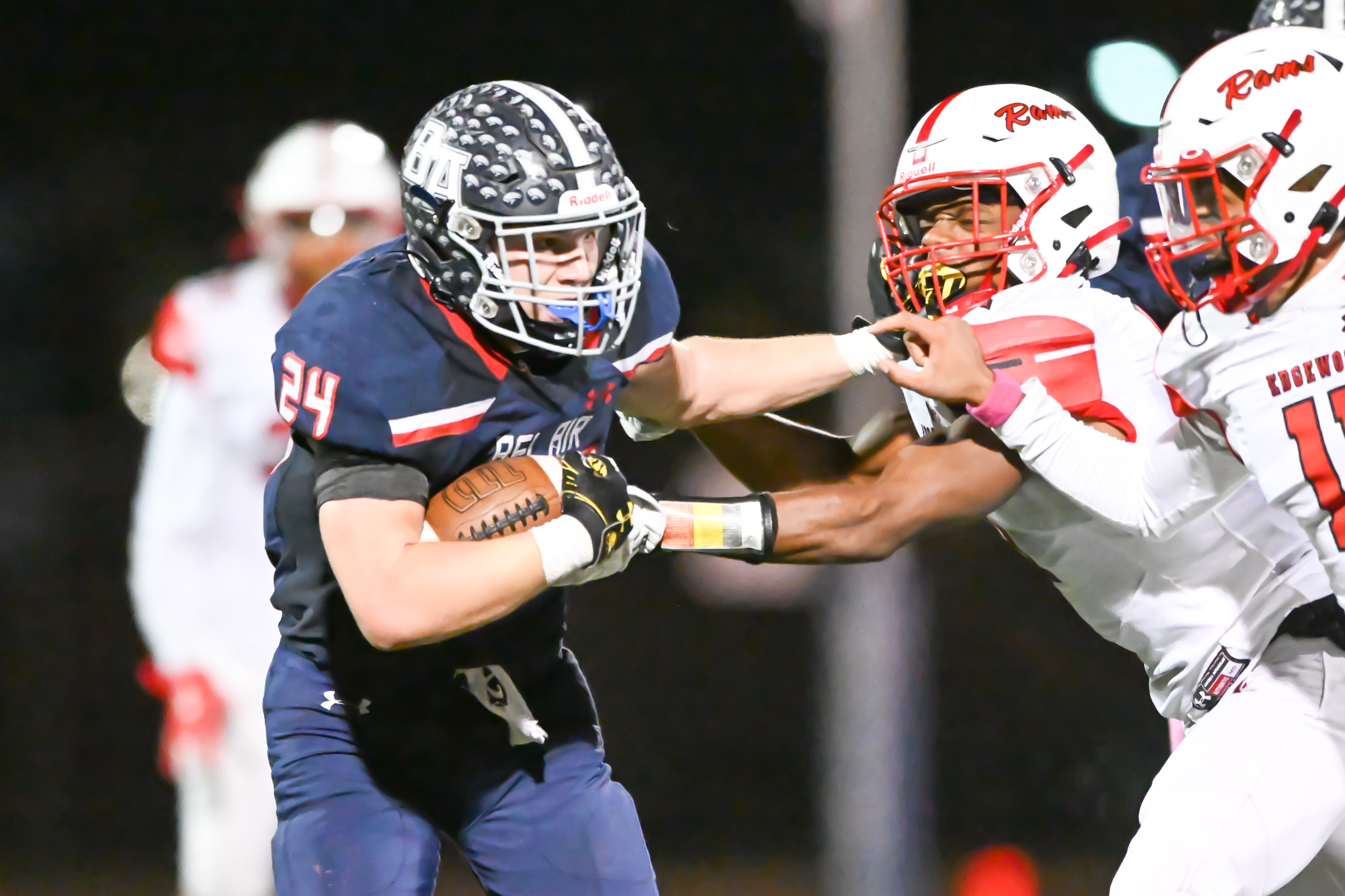 Bel Air running back Nate Furrow (24) fends off Edgewood defenders during Friday's UCBAC Chesapeake football game. Furrow rushed for 85 yards and scored the tying touchdown in the fourth overtime, followed by Devin Trzeciak's clinching extra-point as the host and No. 15 Bobcats clinched first place and an undefeated regular season with a 28-27 victory.