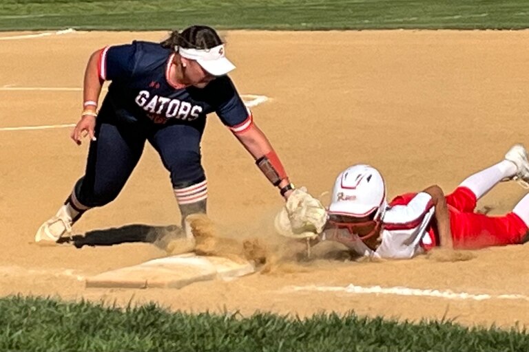 Reservoir first basemen Cambell Sagin (left) puts tag on Glenelg's Abiola Owens on a pickoff play during Thursday's Howard County softball match. The No. 2 Gators improved to 7-0 with a 7-2 victory over the Gladiators in Western Howard County.