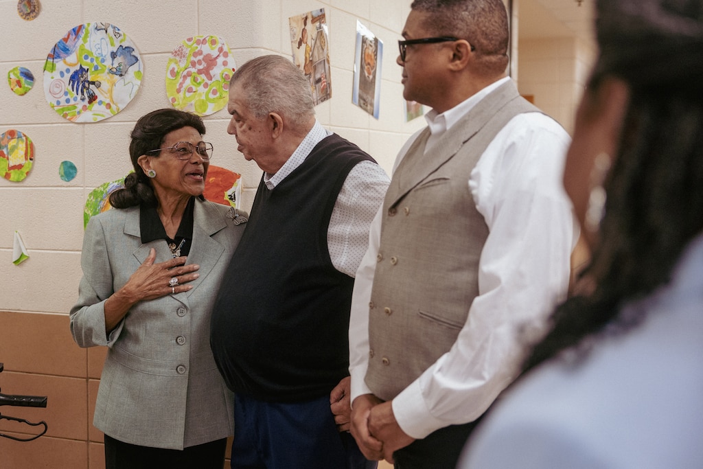 Second grade teacher Estelle Moore (left) thanks her husband Charles Moore Sr. (center) and son Charles Moore Jr. (right) while talking to media inside Greencastle Elementary School, which is celebrating Moore's 55 years in education during Teacher Appreciation Week.