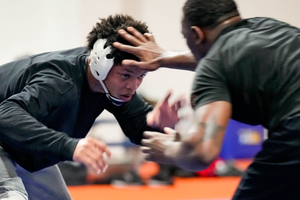 Yannis Charles, left, spars with Quincy Monday during wrestling practice at Hill Field House on Morgan State University’s campus in Baltimore, Md., on Monday, March 16, 2026.