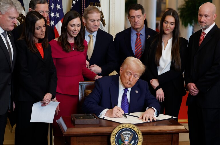 WASHINGTON, DC - JANUARY 29: Surrounded by members of Congress and the family of Laken Riley, U.S. President Donald Trump signs the Laken Riley Act, the first piece of legislation passed during his second term in office, in the East Room of the White House on January 29, 2025 in Washington, DC. Jason Riley and Allyson Philips, the parents of 22-year-old Laken Riley, a University of Georgia nursing student who was murdered in 2024 by an undocumented immigrant, attended the signing ceremony. Among other measures, the law directs law enforcement authorities to detain and deport immigrants who are accused but not yet convicted of specific crimes, if they are in the country illegally. (Photo by Chip Somodevilla/Getty Images)