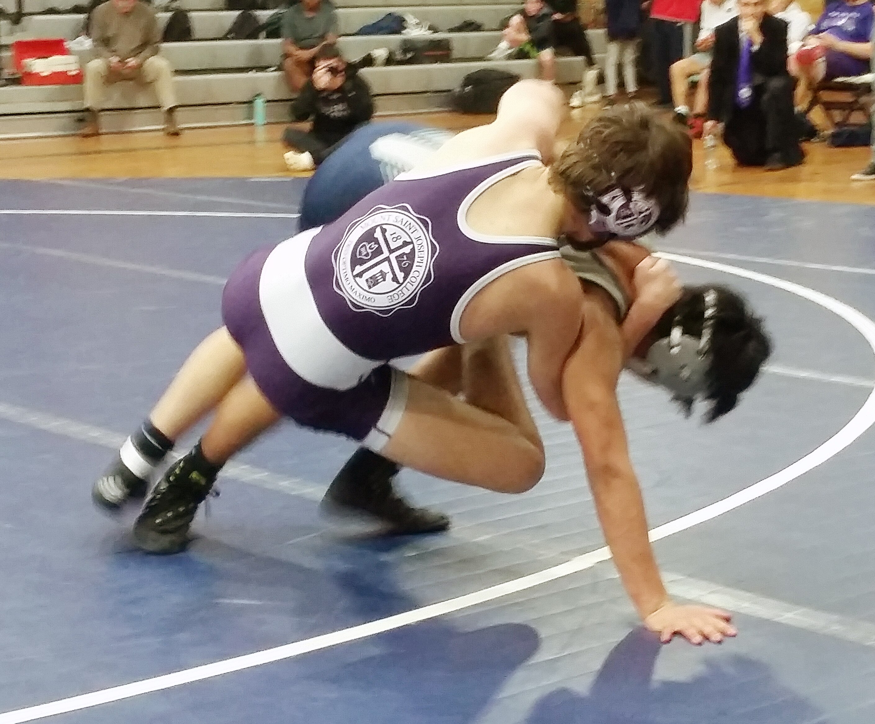 In one of the few matches to go the distance in Wednesday's MIAA A Conference dual between No. 1 Mount St. Joseph and No. 3 Gilman, St. Joe's Carter Nogle (top left), the state's top-ranked wrestler at 120, defeated 5th-ranked Zach Glory of Gilman, 7-2.