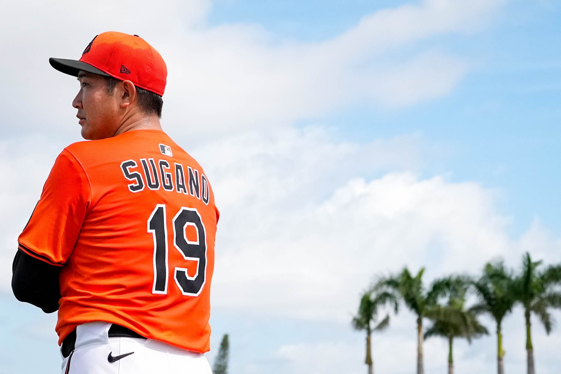 Orioles right-hander Tomoyuki Sugano speaks with interpreter Yuto Sakurai after his first bullpen of spring training.