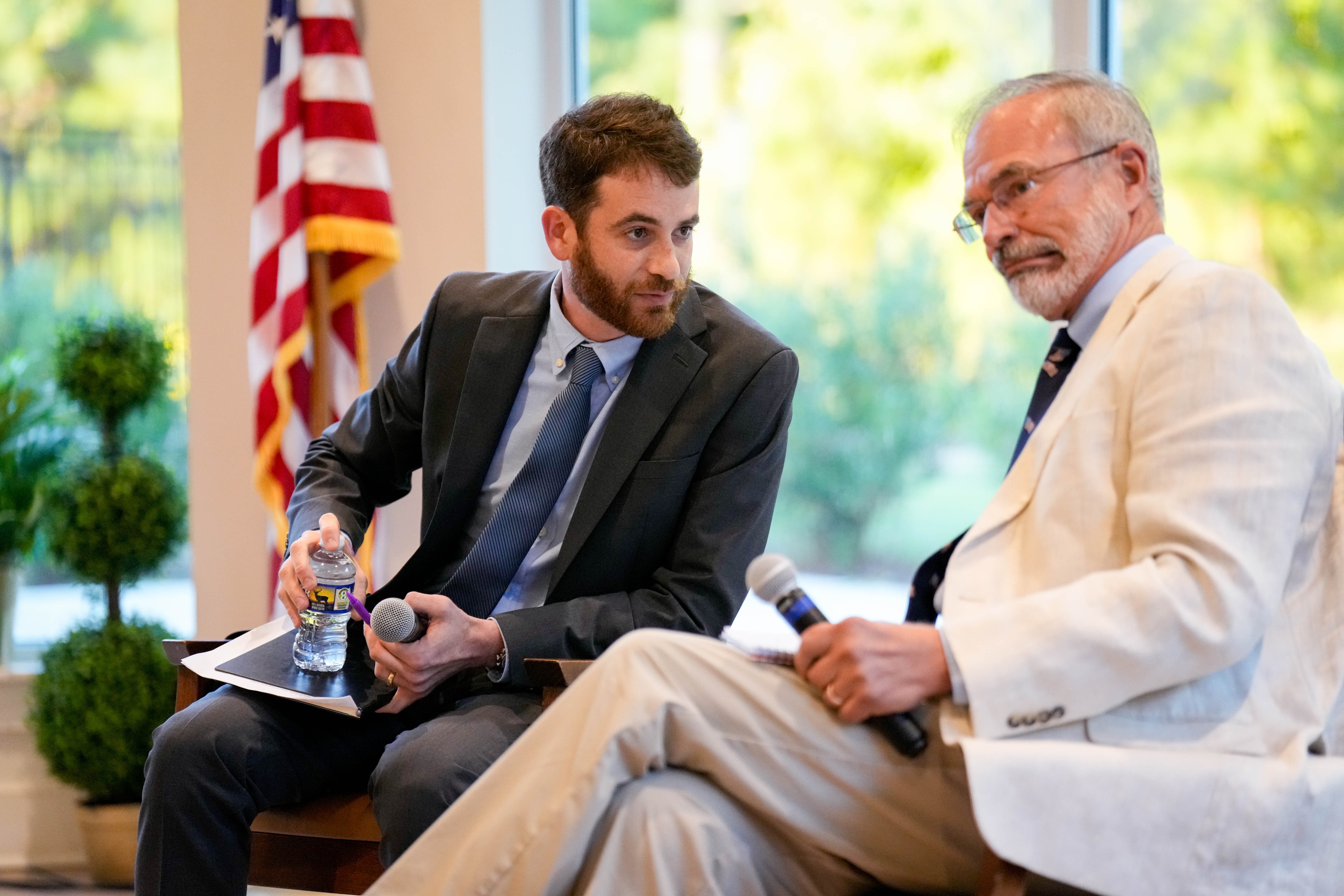 U.S. Rep. Andy Harris, right, and Democratic candidate Dan Schwartz speak to each other ahead of a League of Women Voters forum at the Chesapeake Grove Intergenerational Center in Cambridge on Tuesday.