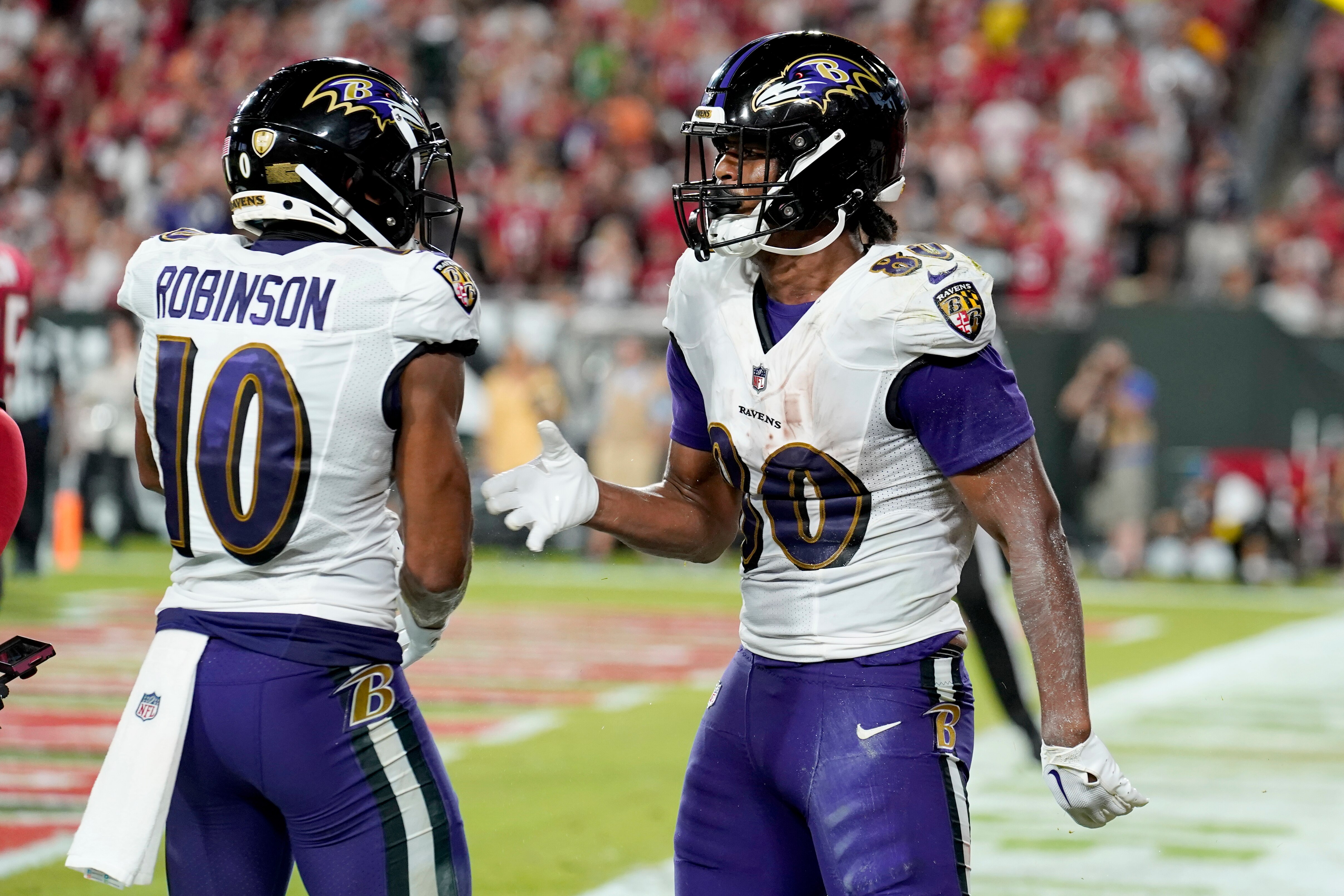 This photo depicts Baltimore Ravens tight end Isaiah Likely, right, being congratulated by teammate Demarcus Robinson (10) after scoring during the second half of an NFL football game against the Tampa Bay Buccaneers Thursday, Oct. 27, 2022, in Tampa, Fla.
