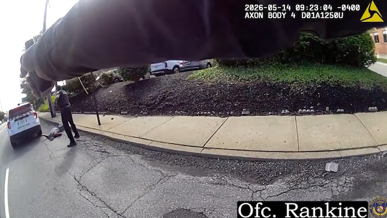 In a still from released body camera footage, Baltimore Police officers opened fire on the Louis Jackson, who had run at Officer Sharod Watson and fired a revolver at him during an apparent mental health crisis.