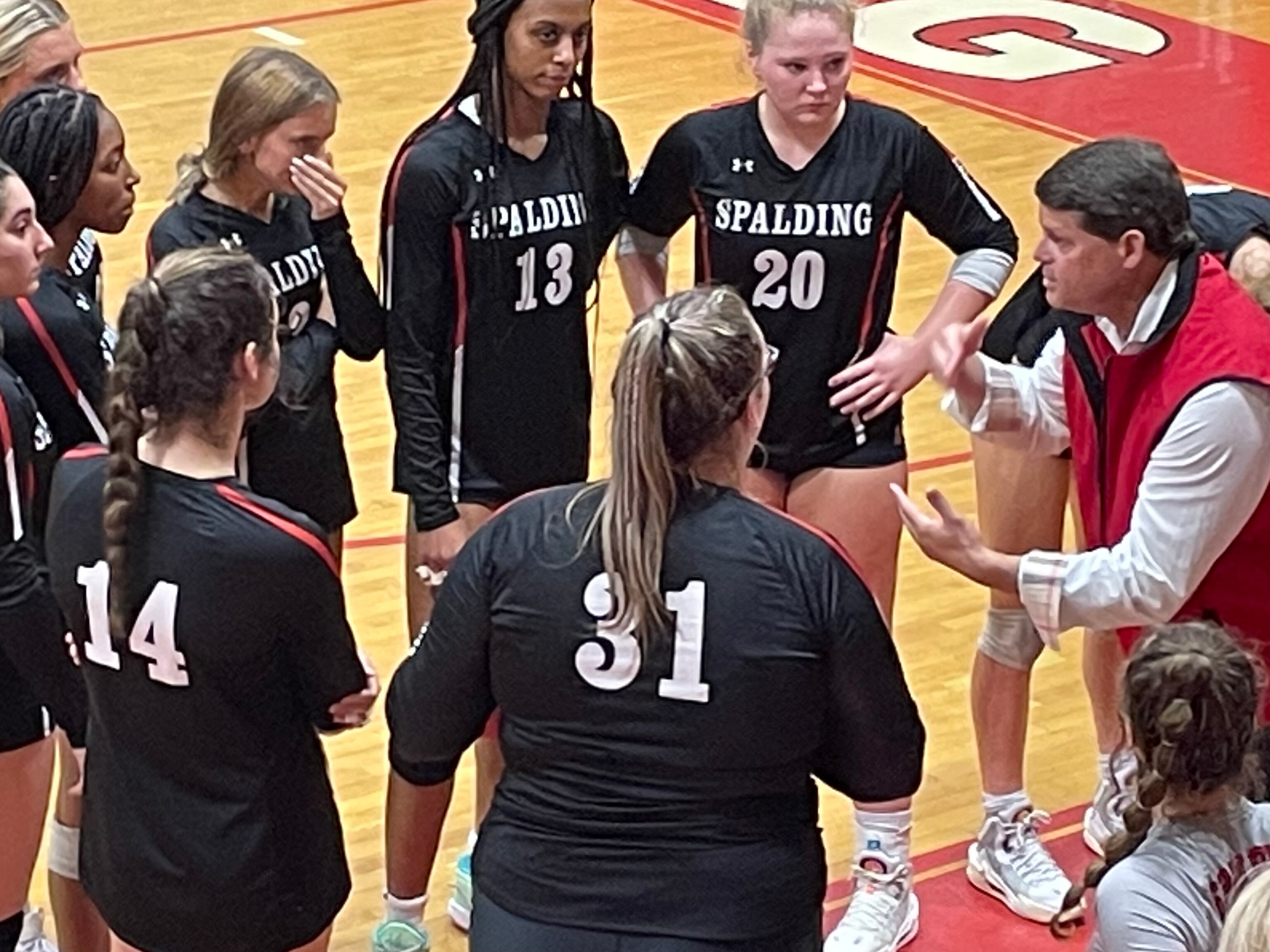 Archbishop Spalding coach Corby Lawrence rallies his team during a first-set timeout and the Cavaliers went on to sweep Maryvale Prep and avenge their loss in last season’s IAAM A Conference championship match.