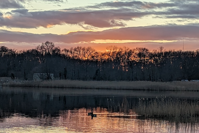 This time of year, the sun sets before 4:30 and dips below the bare trees on Fishing Creek beneath a sky full of gray clouds.