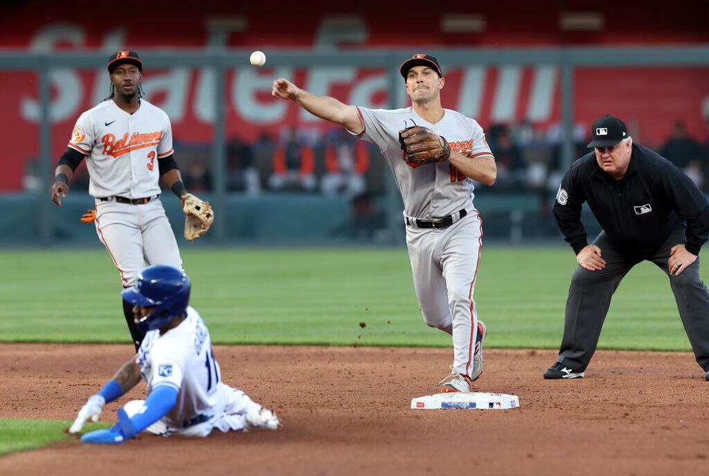 KANSAS CITY, MISSOURI - MAY 03:  Adam Frazier #12 of the Baltimore Orioles turns a double play as Maikel Garcia #11 of the Kansas City Royals slides into second base during the game at Kauffman Stadium on May 03, 2023 in Kansas City, Missouri.