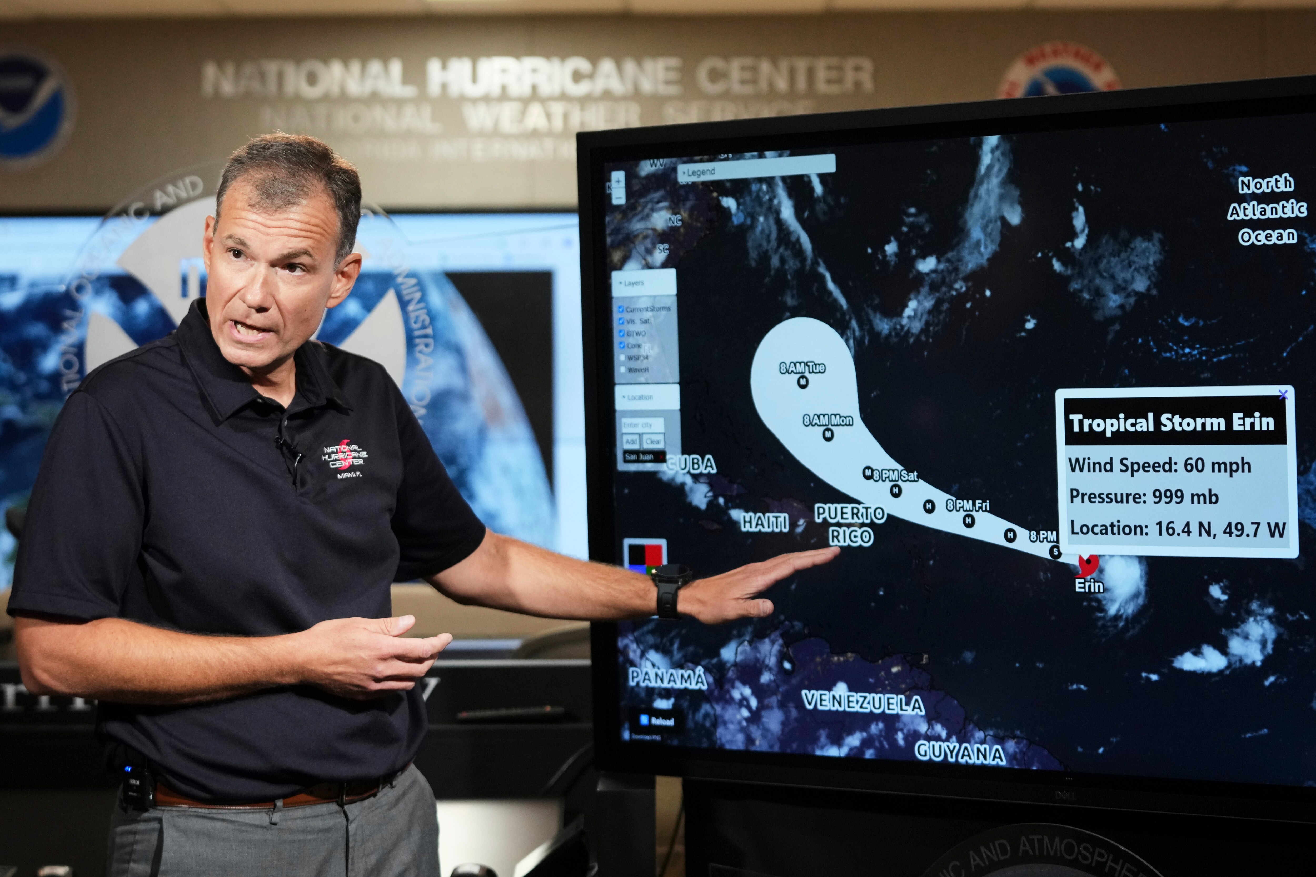 Jamie Rhome, deputy director of the National Hurricane Center, gives an update on Tropical Storm Erin at the National Hurricane Center, Thursday, Aug. 14, 2025, in Miami. (AP Photo/Lynne Sladky)