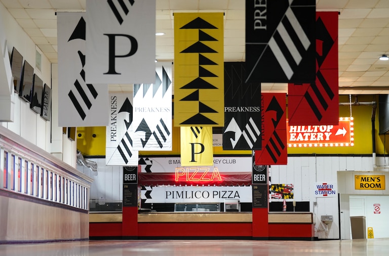 Preakness flags hang inside the main concourse at Pimlico Race Course in Baltimore, Md. on Monday, May 12, 2025.