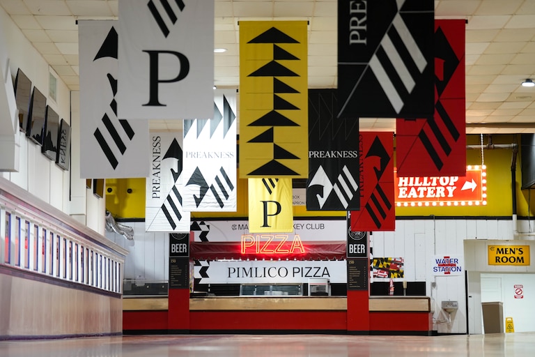 Preakness flags hang inside the main concourse at Pimlico Race Course in Baltimore, Md. on Monday, May 12, 2025.