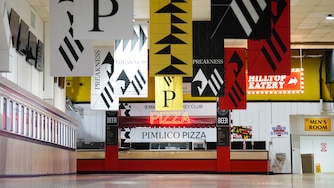 Preakness flags hang inside the main concourse at Pimlico Race Course in Baltimore, Md. on Monday, May 12, 2025.