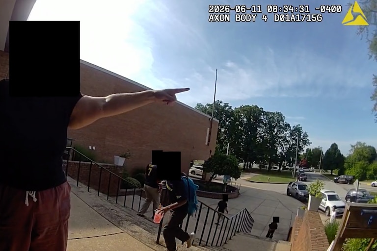 Woman points to the location of ICE arrests at the school.