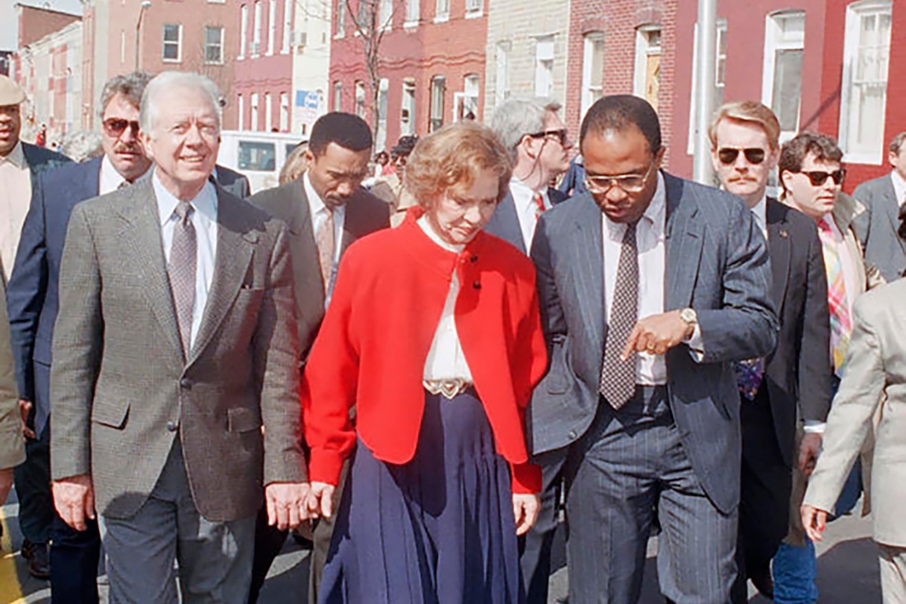 Former Pres. Jimmy Carter, left, and Rosalynn Carter, center, get a tour of the Sandtown Project by Baltimore Mayor Kurt Schmoke, right, Friday, March 27, 1992, Baltimore, Md. The Carter's were in town to kick off the Sandtown Habitat for Humanity campaign which will rehabilitate 100 vacant homes.