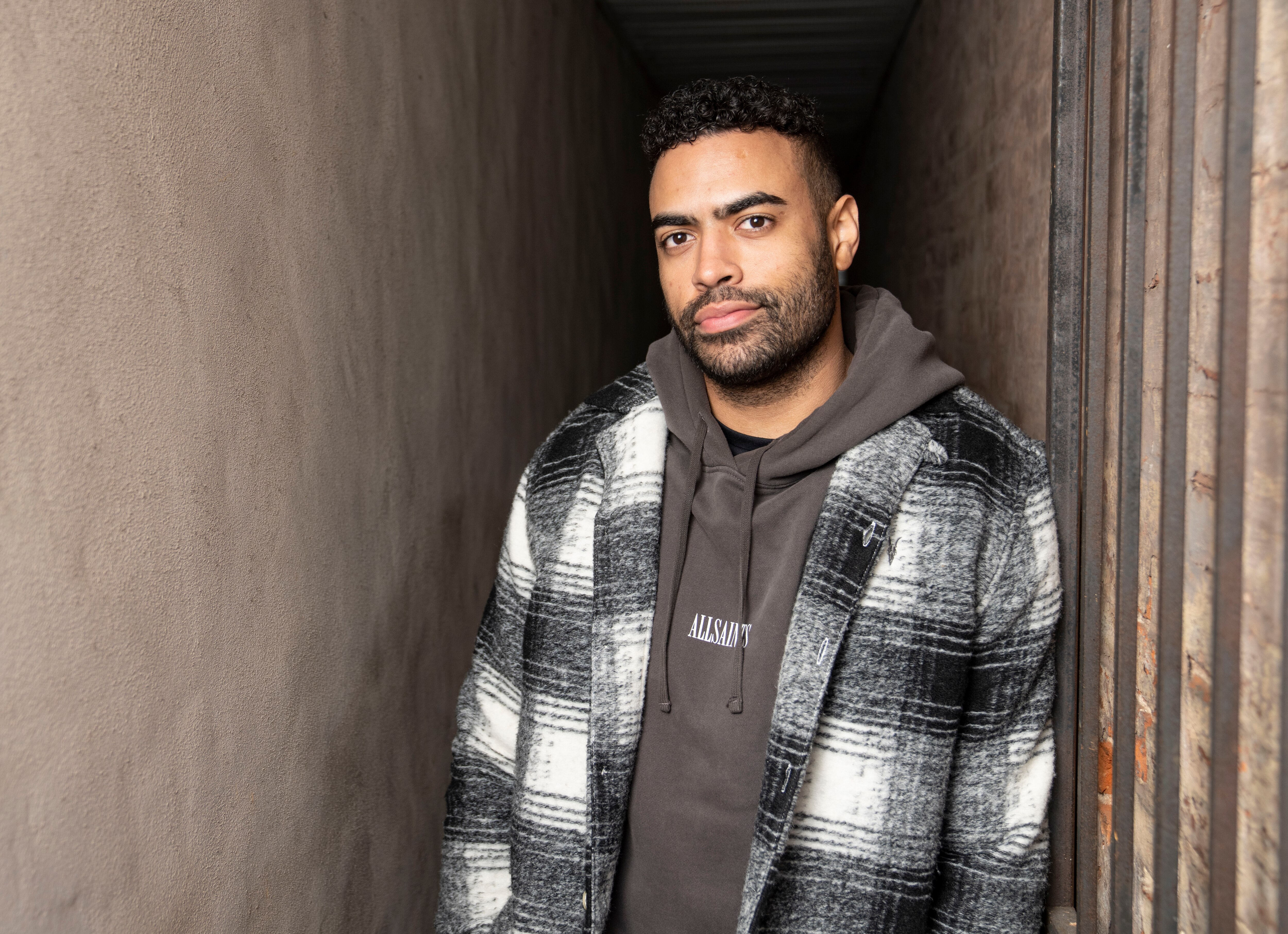 Justin Glaze poses for a portrait outside of his home in Baltimore