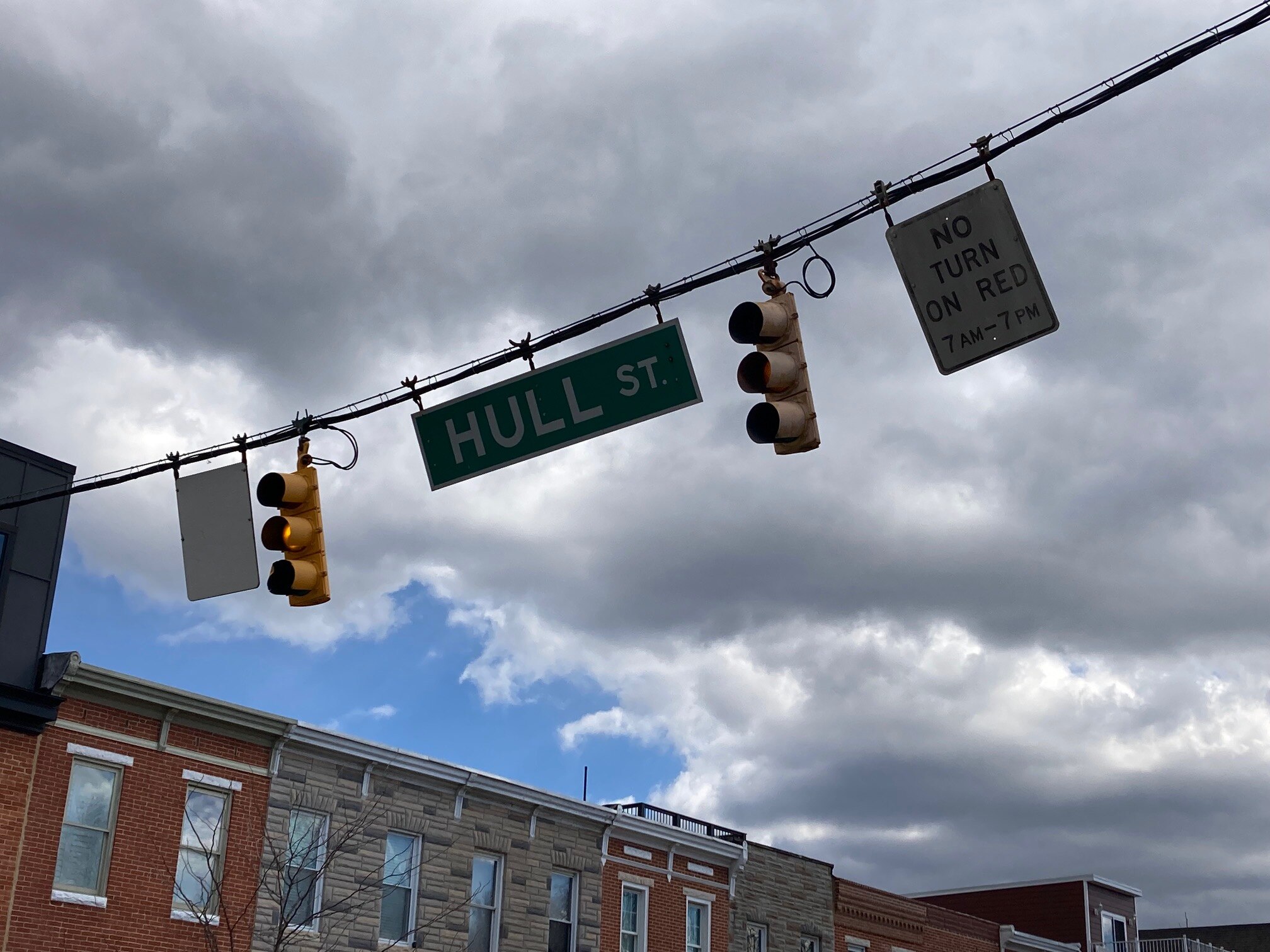 Traffic signals at East Fort Avenue and Hull Street in South Baltimore sway in the wind on Sunday, March 10, 2024.