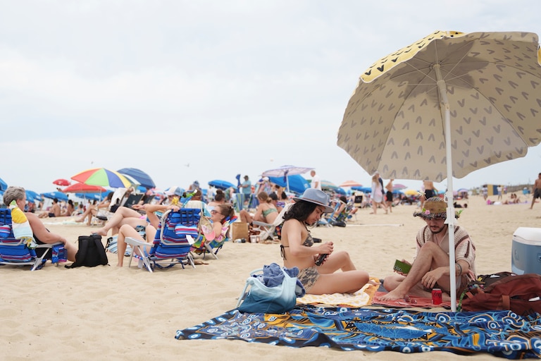 People relax in Rehoboth Beach, Del., despite a heat advisory warning from the National Weather Service on Sunday, June 22, 2025.