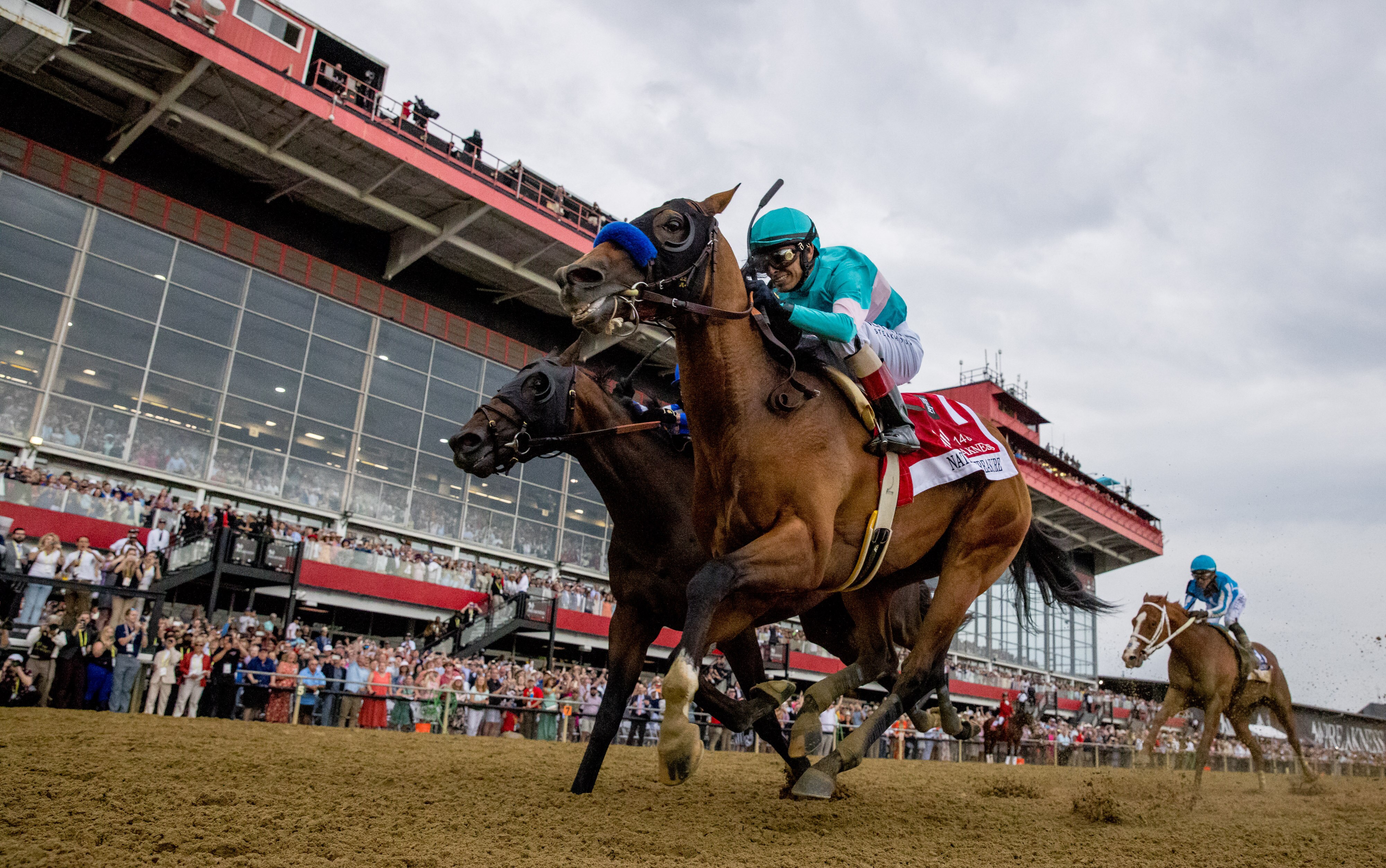 National Treasure, ridden by jockey John Velazquez, wins the 2023 Preakness Stakes at Pimlico Race Course. The state is soon to take over and renovate the historic track, and is changing course in how the project will be managed.