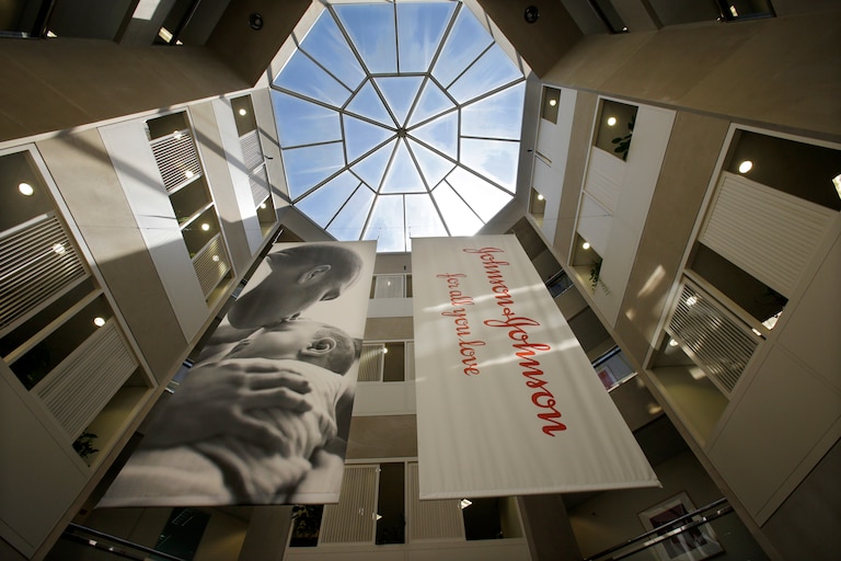 FILE - In this July 30, 2013, file photo, large banners hang in an atrium at the headquarters of Johnson & Johnson in New Brunswick, N.J.
