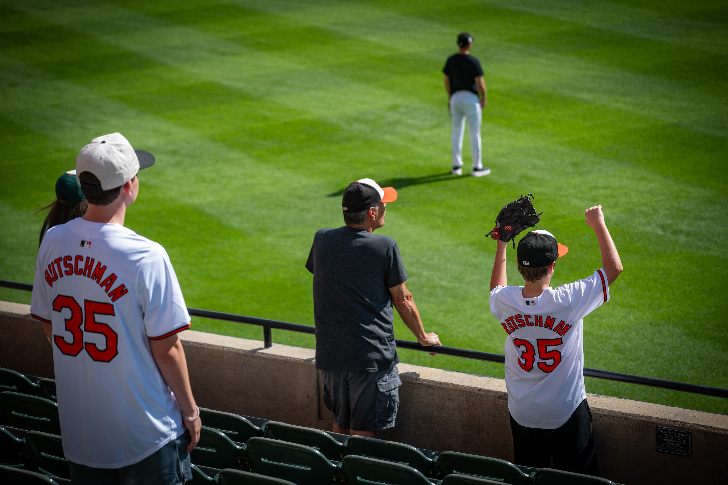 Nolan Catterton, 12, right, waits for a ball to come his way during batting practice at Oriole Park a day after catcher Adley Rutschman was traded to the Boston Red Sox. 