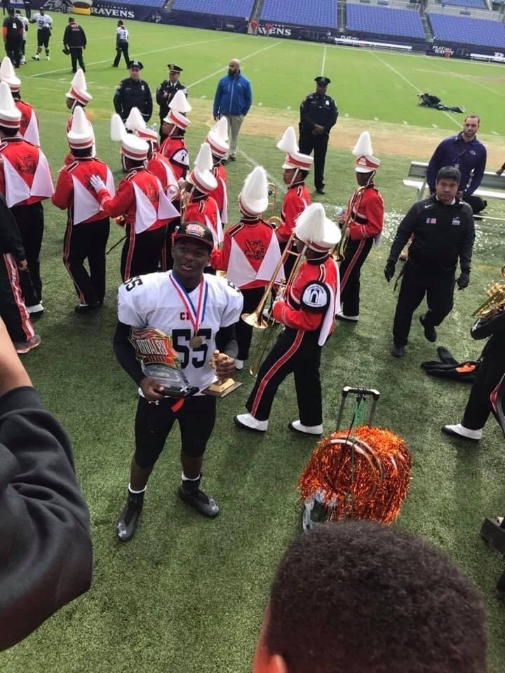 Malik Hamm poses with the MVP trophy after leading Baltimore City College to a win over Polytechnic in 2017. Hamm is now hoping to make the Baltimore Ravens out of training camp as an outside linebacker. (Photo courtesy of Mia Hamm)