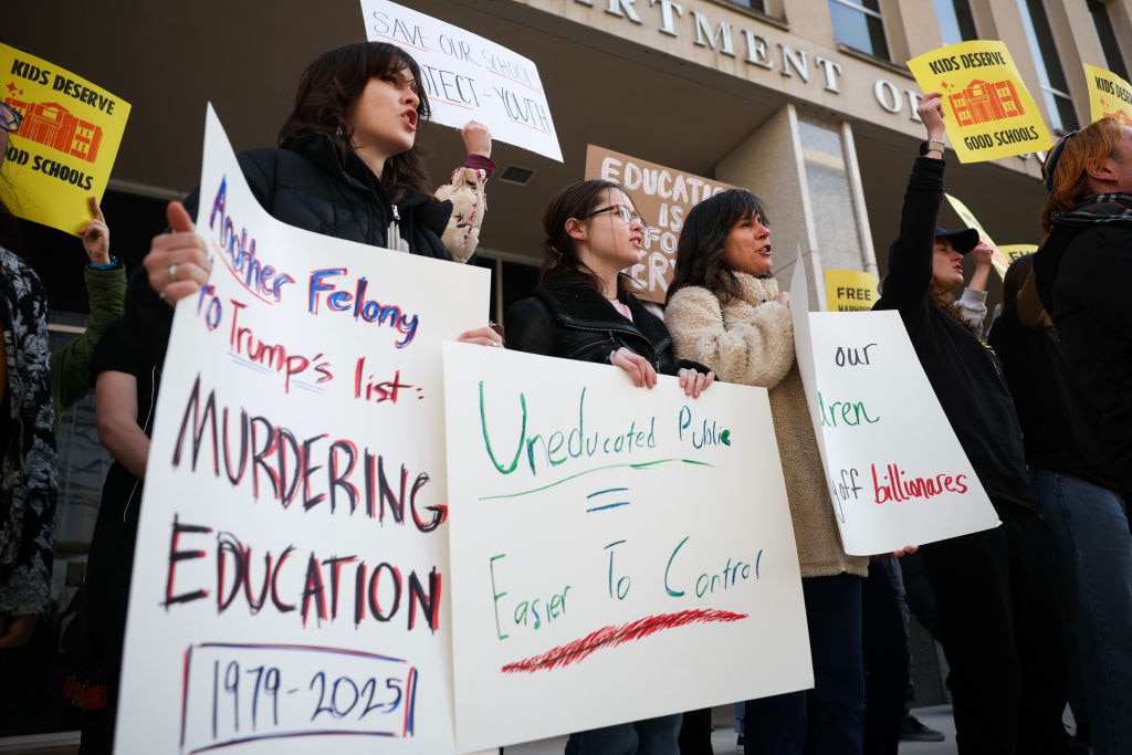 Community members rally in front of the Department of Education to protest budget cuts on March 13, 2025 in Washington, DC.