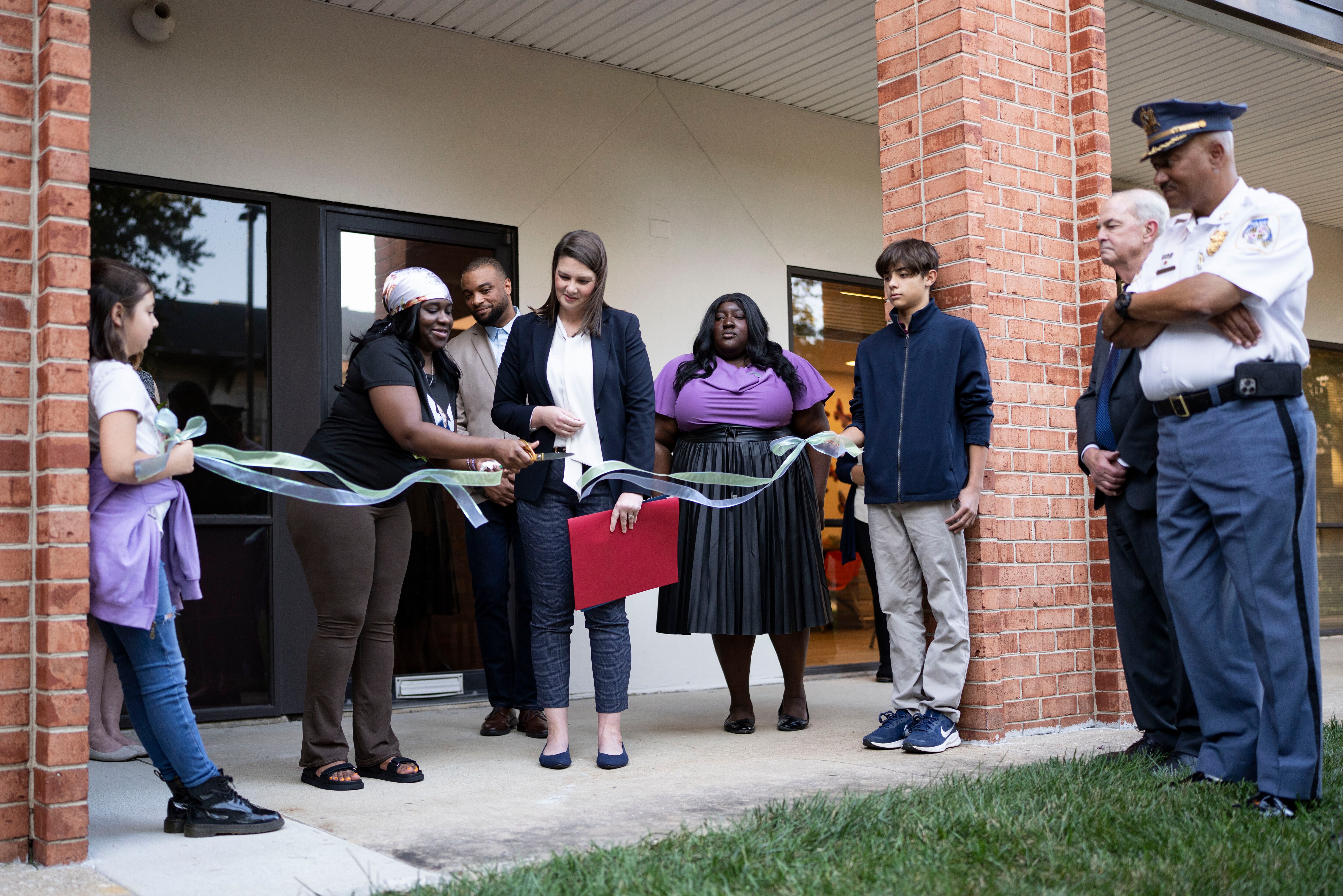 Promyss Marcelle, left, cuts a ribbon marking the renaming of the Jacobi Center in Dundalk.