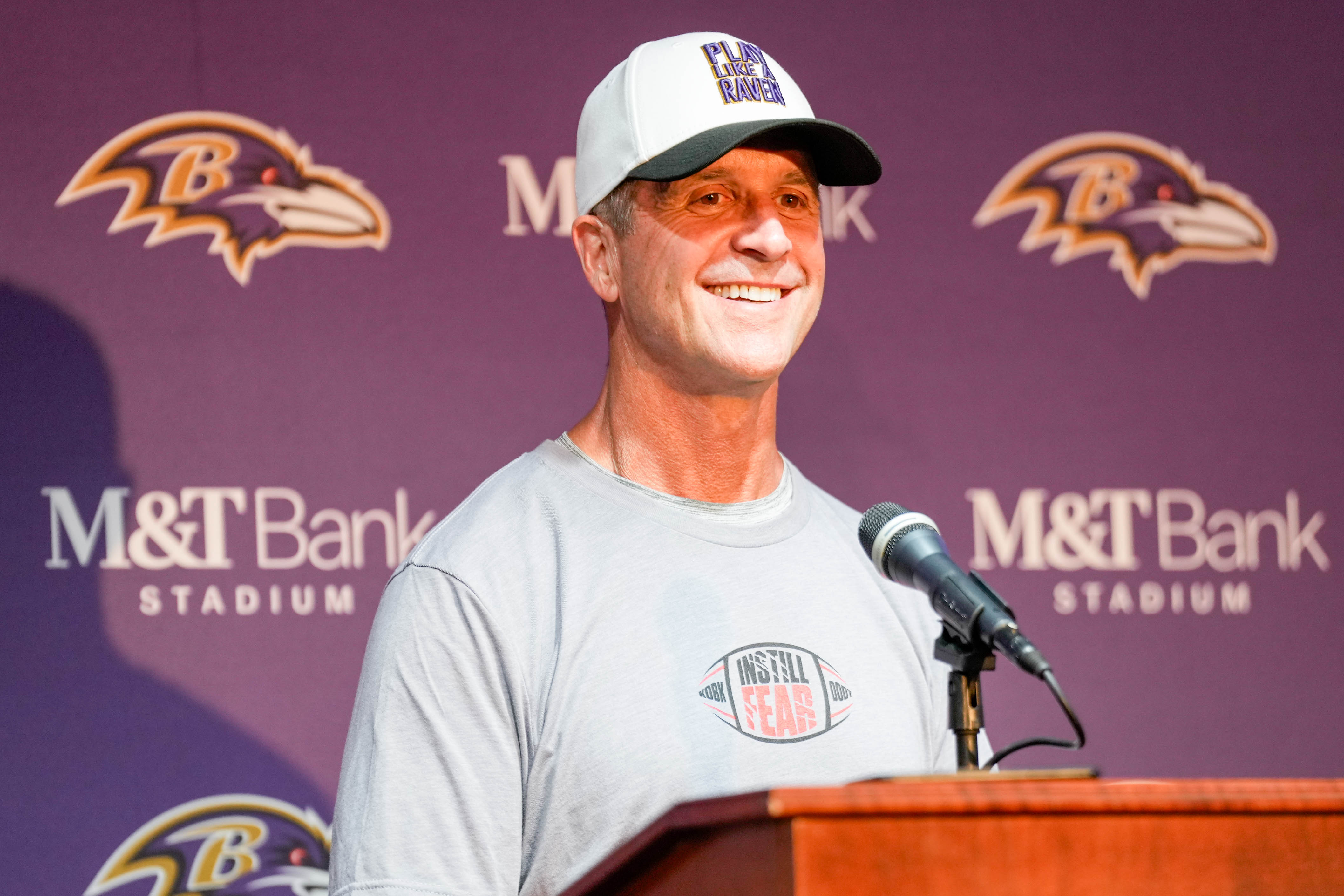 Ravens coach John Harbaugh takes questions from reporters after the teams practice at M&T Bank Stadium on Sunday.