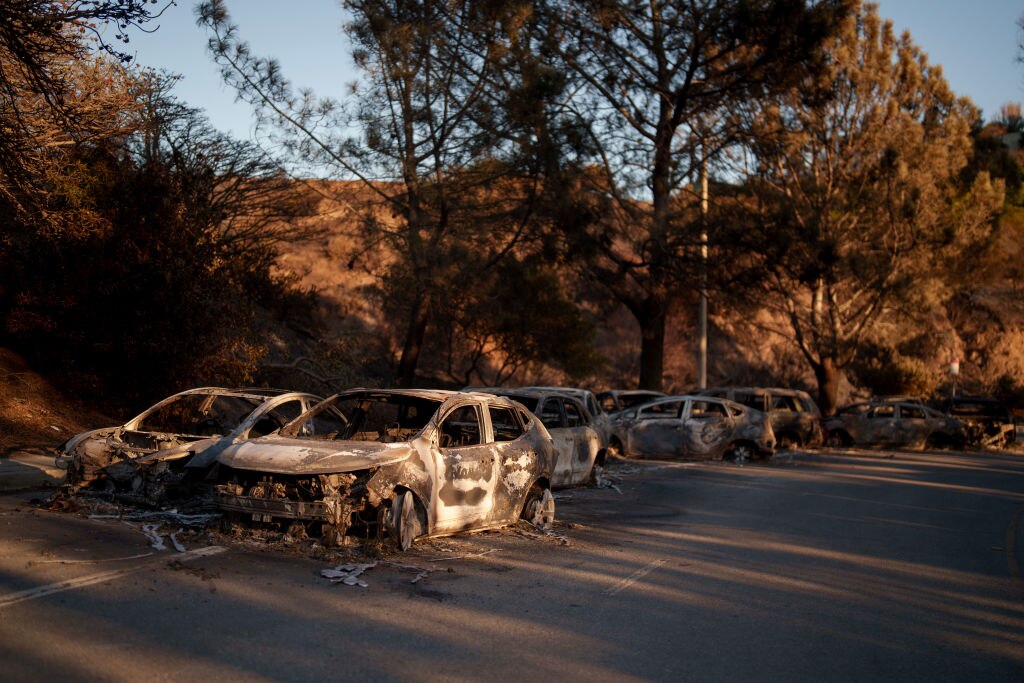 Destroyed cars are seen in the Pacific Palisades neighborhood of Los Angeles, California.