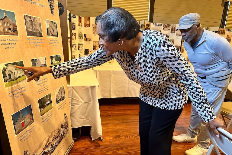 Campfield A.M.E.'s pastor, Rev. Rowena White, points to a photo of her congregation inside the Diggs-Johnson Museum, dedicated to preserving African-American heritage in Baltimore County, including the area's rich history of Black churches. White is pictured in Woodstock, Maryland on Wednesday, Aug. 26, 2026.