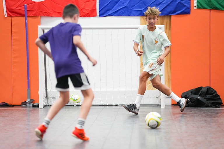 Edward Sroka, right, receives a pass from Matthew Weidman at the Find Your Finesse futsal training center inside the Eastpoint Mall in Dundalk, Md. on Monday, August 17, 2026. The Eastpoint Mall is set to close at the end of August.
