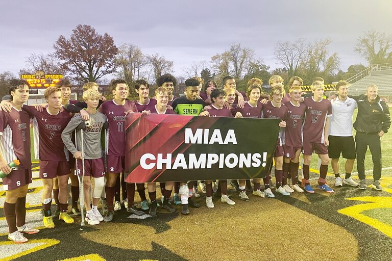 The Severn Admirals pose with a banner that proclaims their second straight MIAA B Conference soccer championship.
