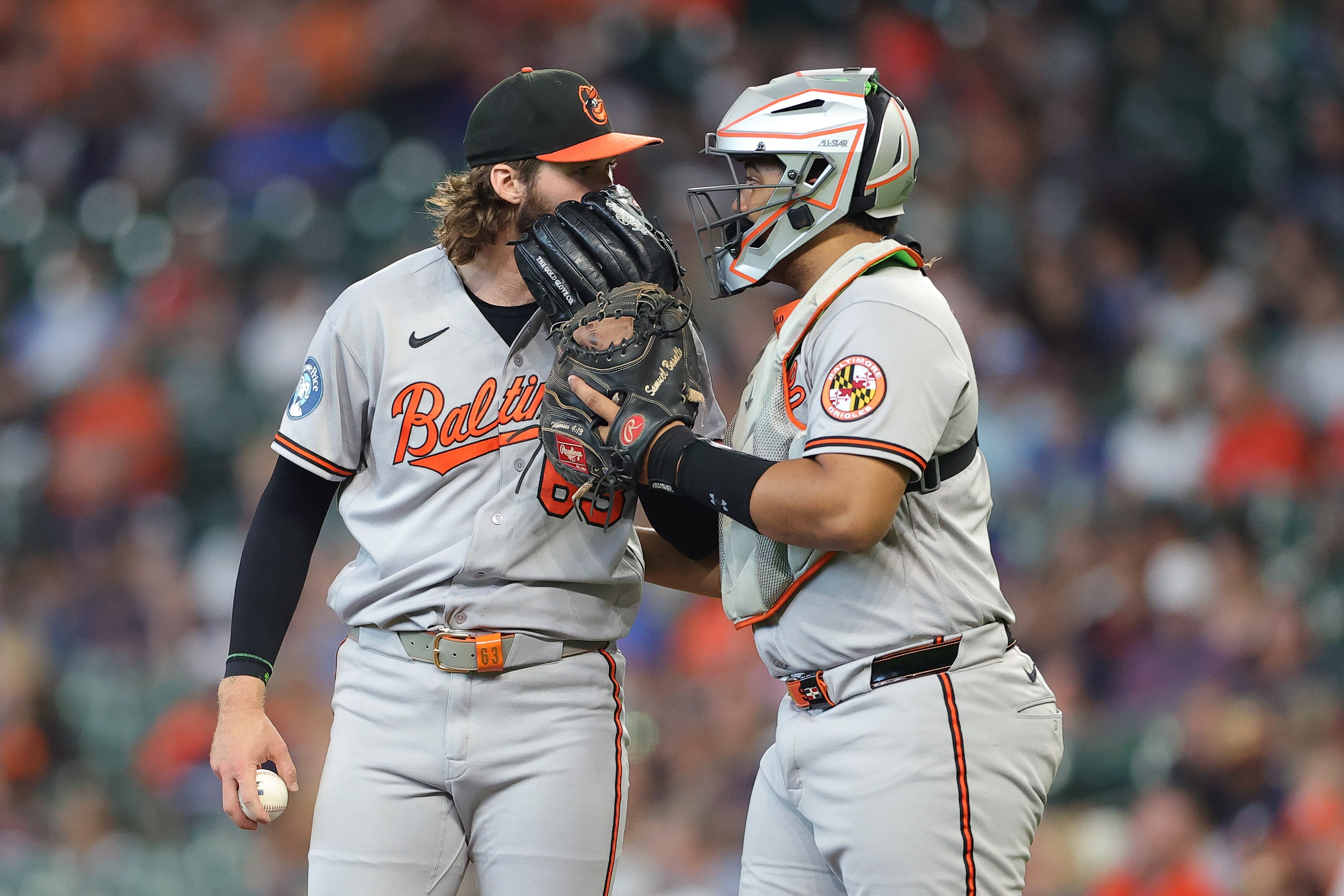 Catcher Samuel Basallo talks with pitcher Brandon Young during the first inning Sunday in Houston.