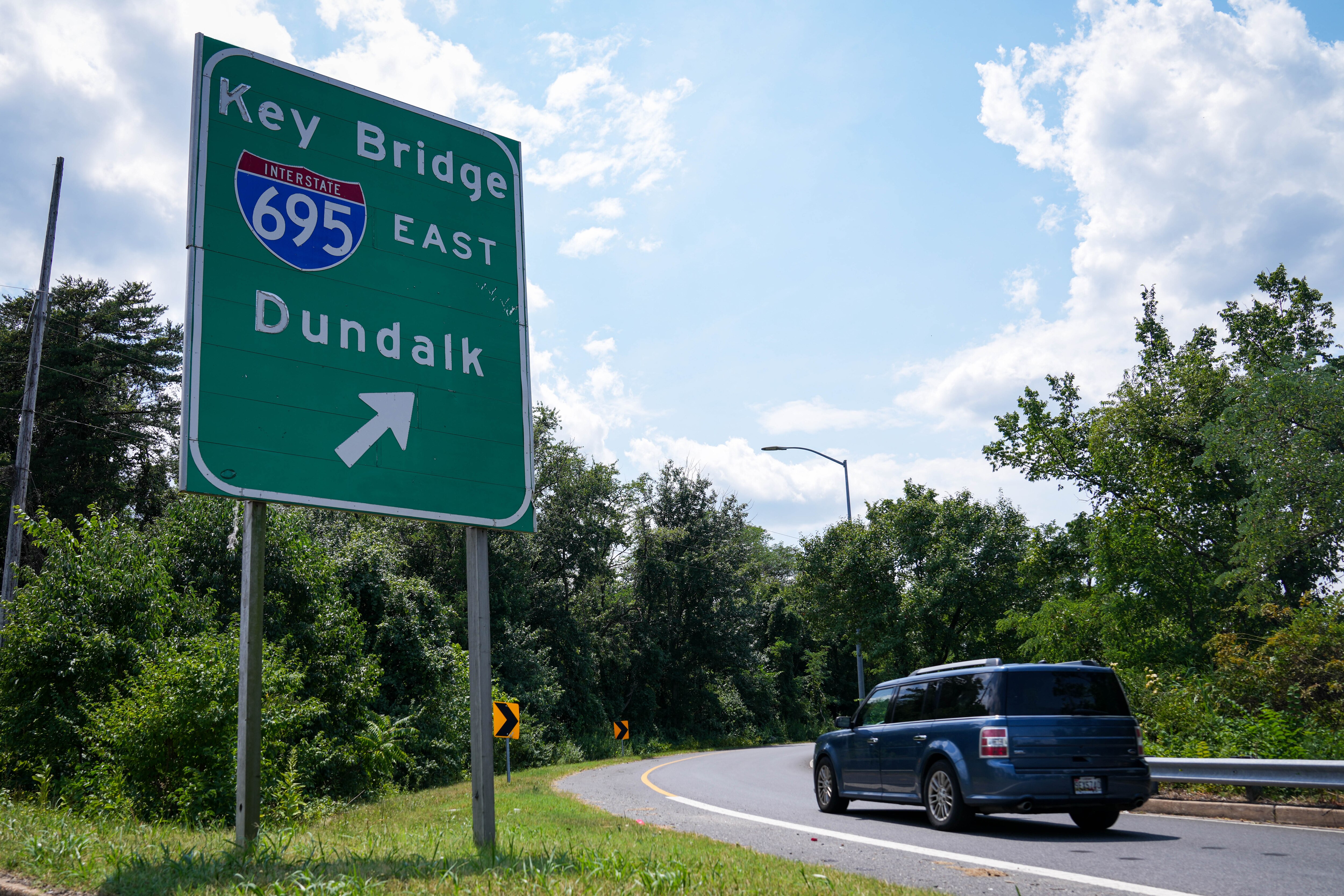 A sign directing drivers in the direction of the now collapsed Francis Scott Key Bridge is seen from the side of Route 2 South on July 17, 2024.