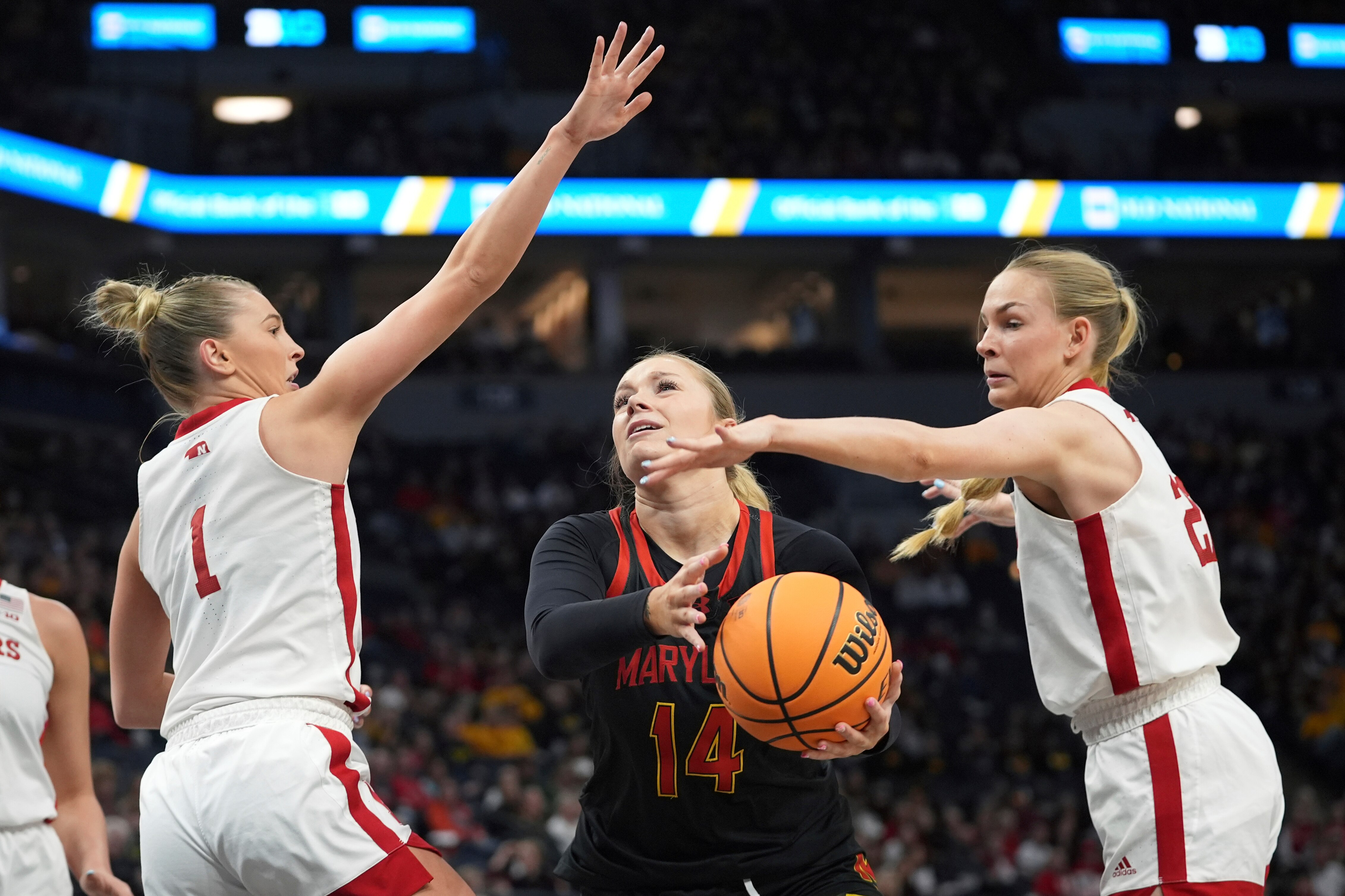 Maryland forward Allie Kubek is defended by Nebraska guard Jaz Shelley (1) and forward Natalie Potts during the first half.
