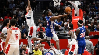 Philadelphia 76ers guard Tyrese Maxey (0) goes to shoot past Washington Wizards guard Will Riley during the first half.