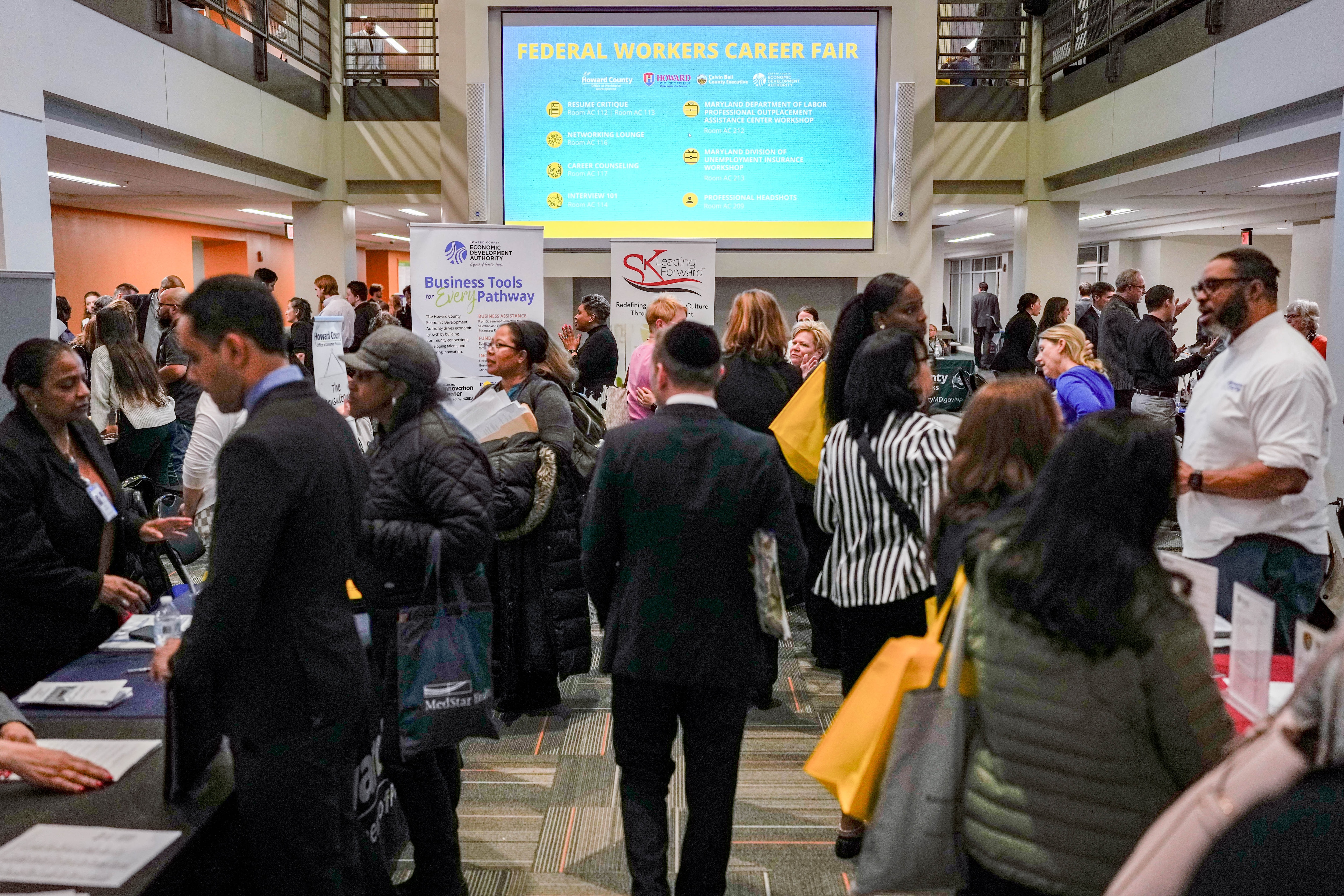 Prospective job seekers speak with recruiters during a career fair hosted at Howard Community College in April.