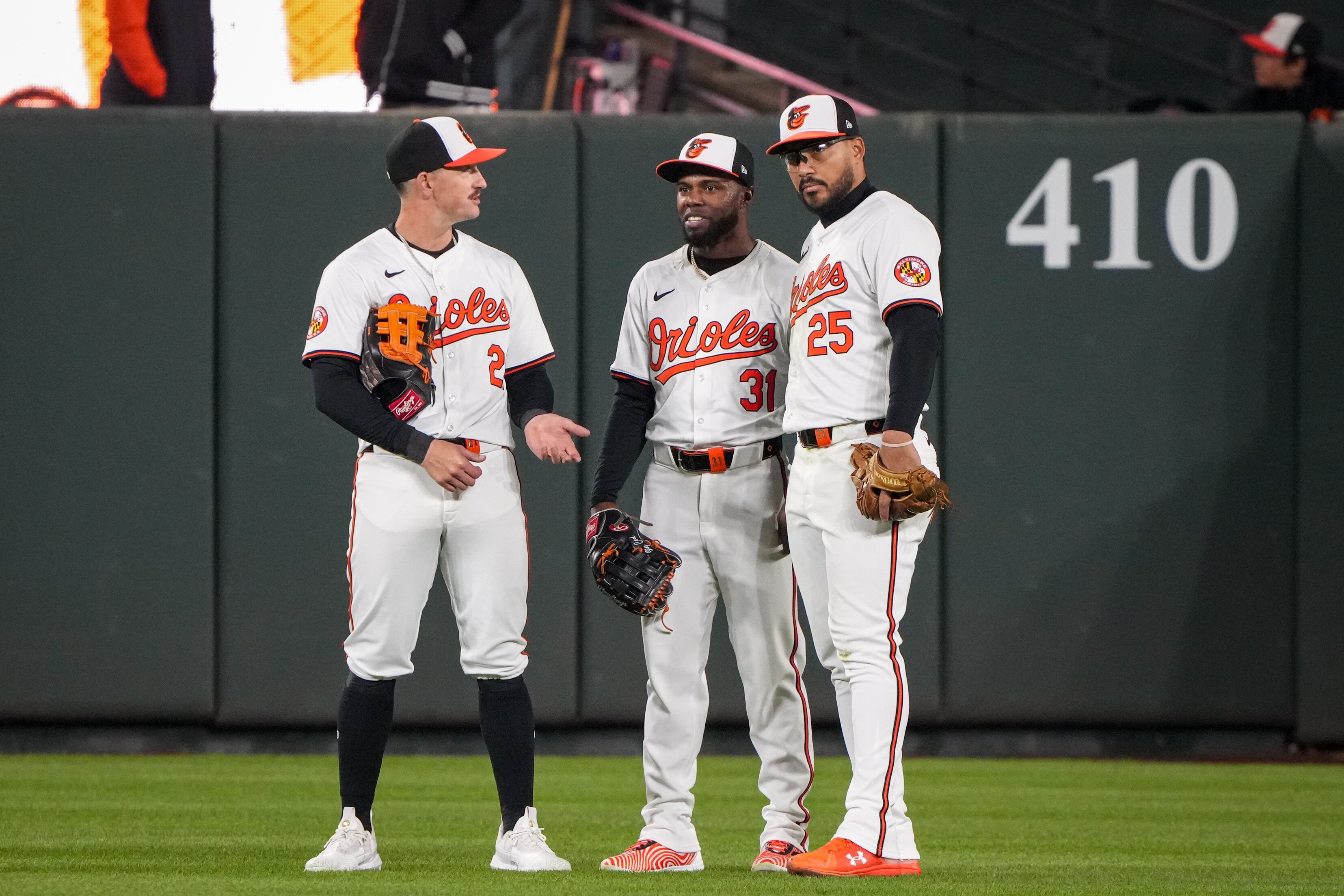 Baltimore Orioles outfielders Austin Hays, Cedric Mullins and Anthony Santander speak during a pitching change in a game against the Kansas City Royals on April 1.