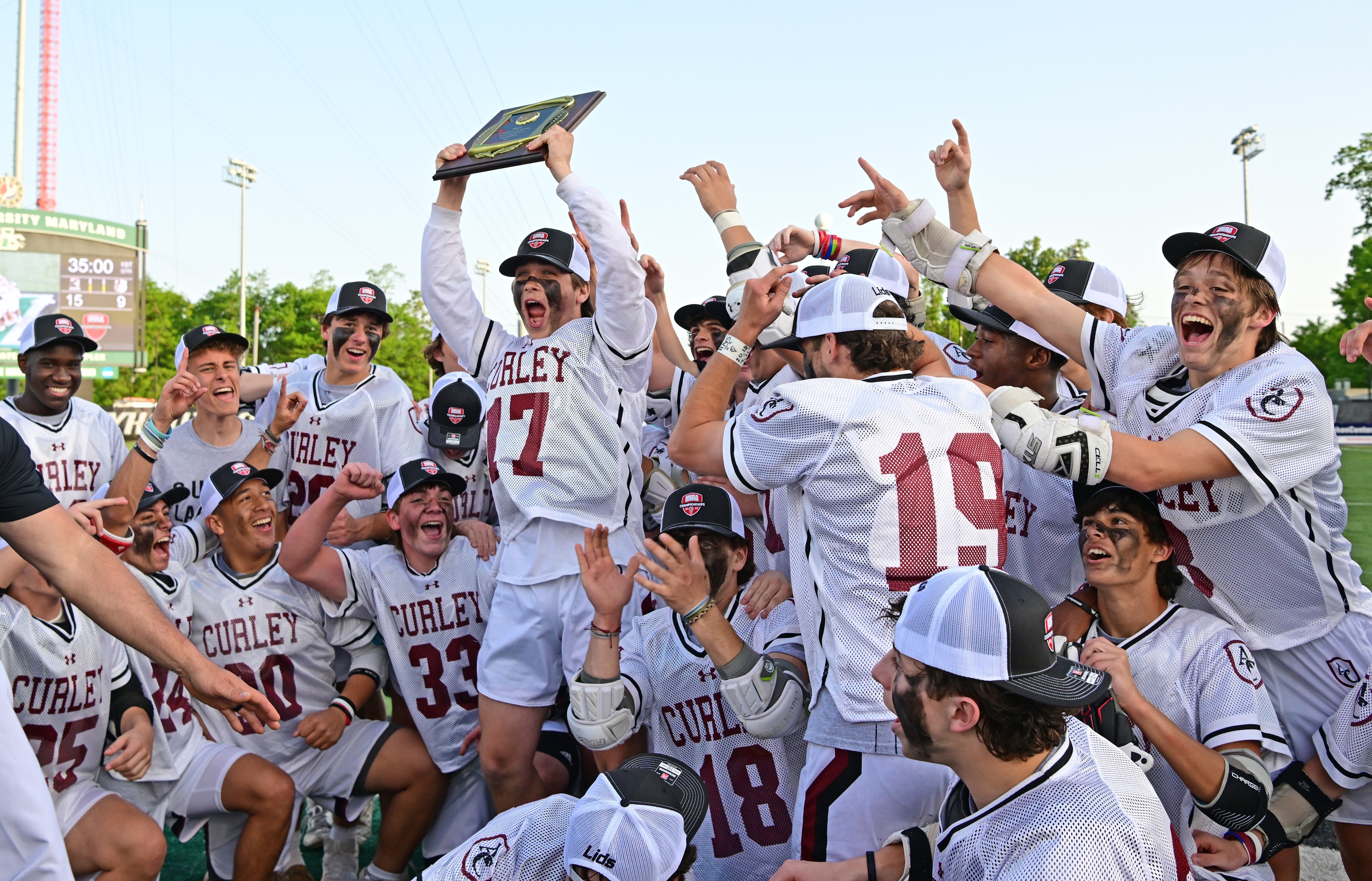 Curley lacrosse captain Hunter Barton holds up the MIAA B Conference lacrosse championship plaque Friday. The Friars repeated as champions with a 15-9 victory over Park at Loyola University's Ridley Athletic Complex.