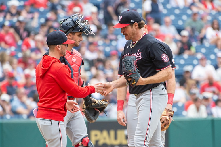 Washington Nationals right-hander Miles Mikolas hands the ball to manager Blake Butera as he leaves during the fifth inning.