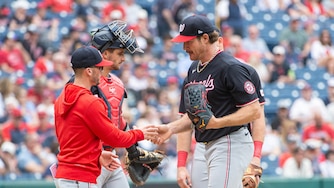 Washington Nationals right-hander Miles Mikolas hands the ball to manager Blake Butera as he leaves during the fifth inning.