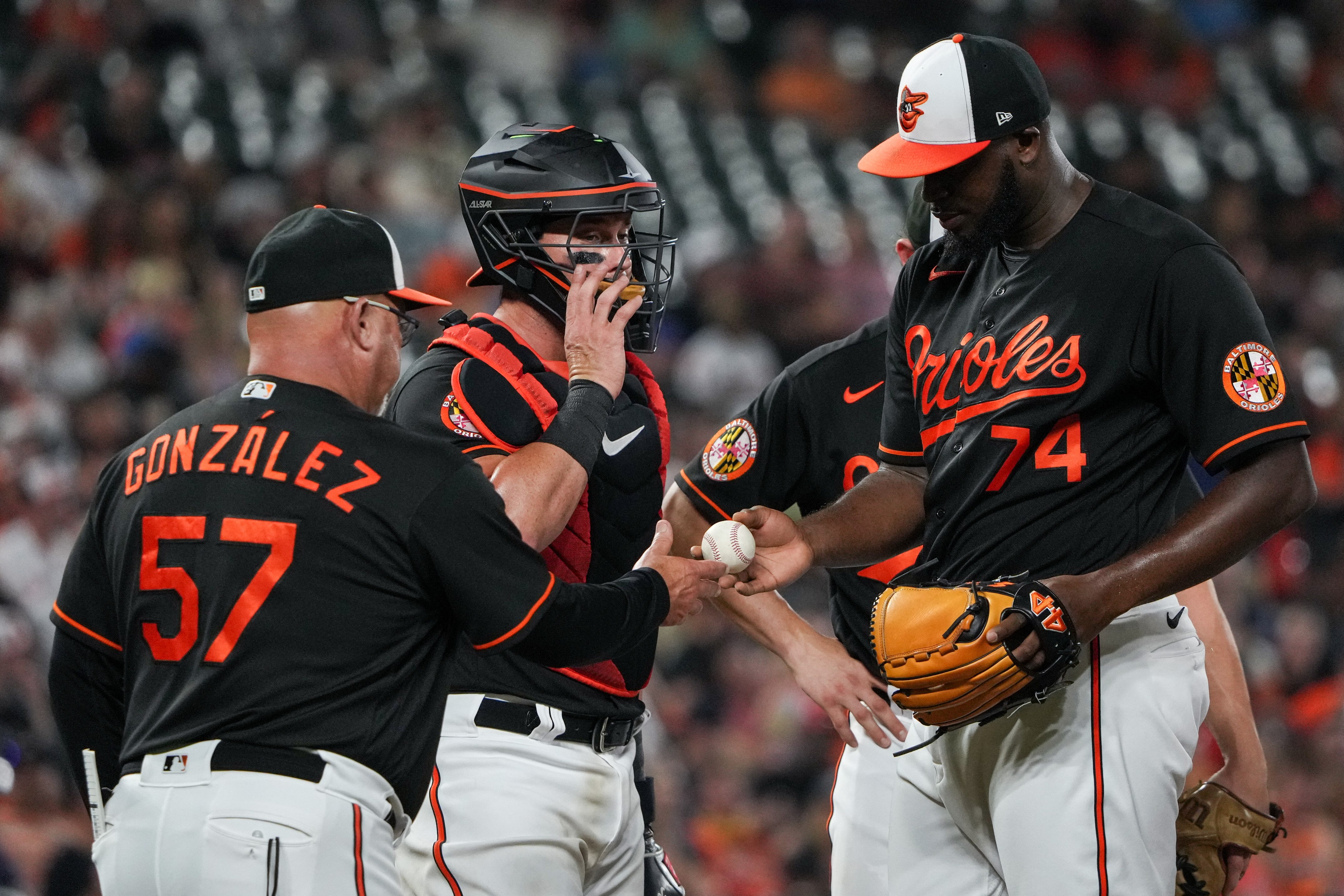 Baltimore Orioles relief pitcher Felix Bautista (74) is pulled from the game by acting manager bench coach Fredi González (57) in the ninth inning of a baseball game against the Houston Astros at Oriole Park at Camden Yards in Baltimore on Aug. 8, 2023.