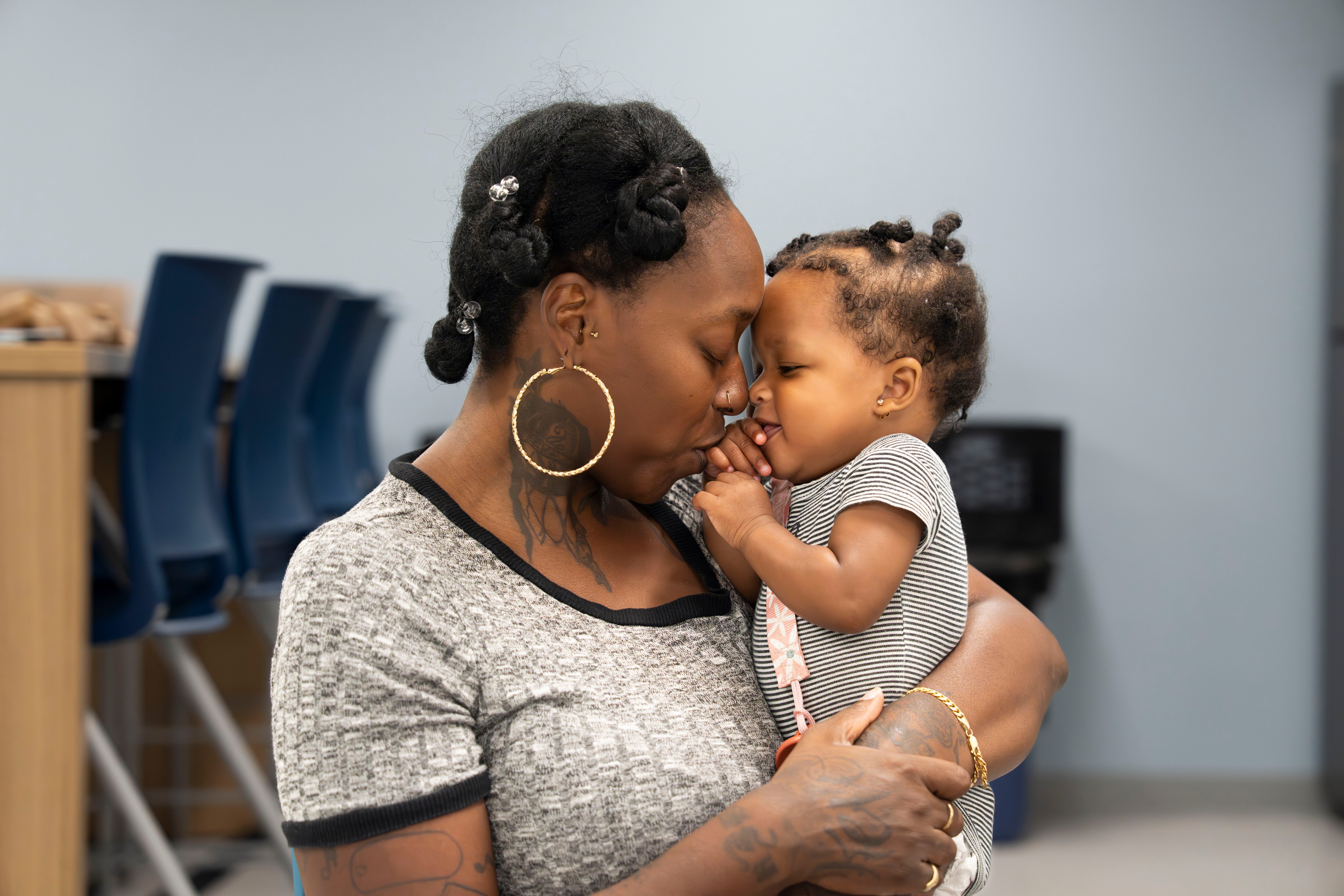 New mother Brittany Brinkley feeds and plays with daughter Bobbee Battle, 10 months, at the Rise Early Learning and Family Support Center. The center is apart of the University of Maryland Baltimore School of Social Work, provides free, high-quality early childhood education, family support services, workforce development, and parent education programs all under one roof.
