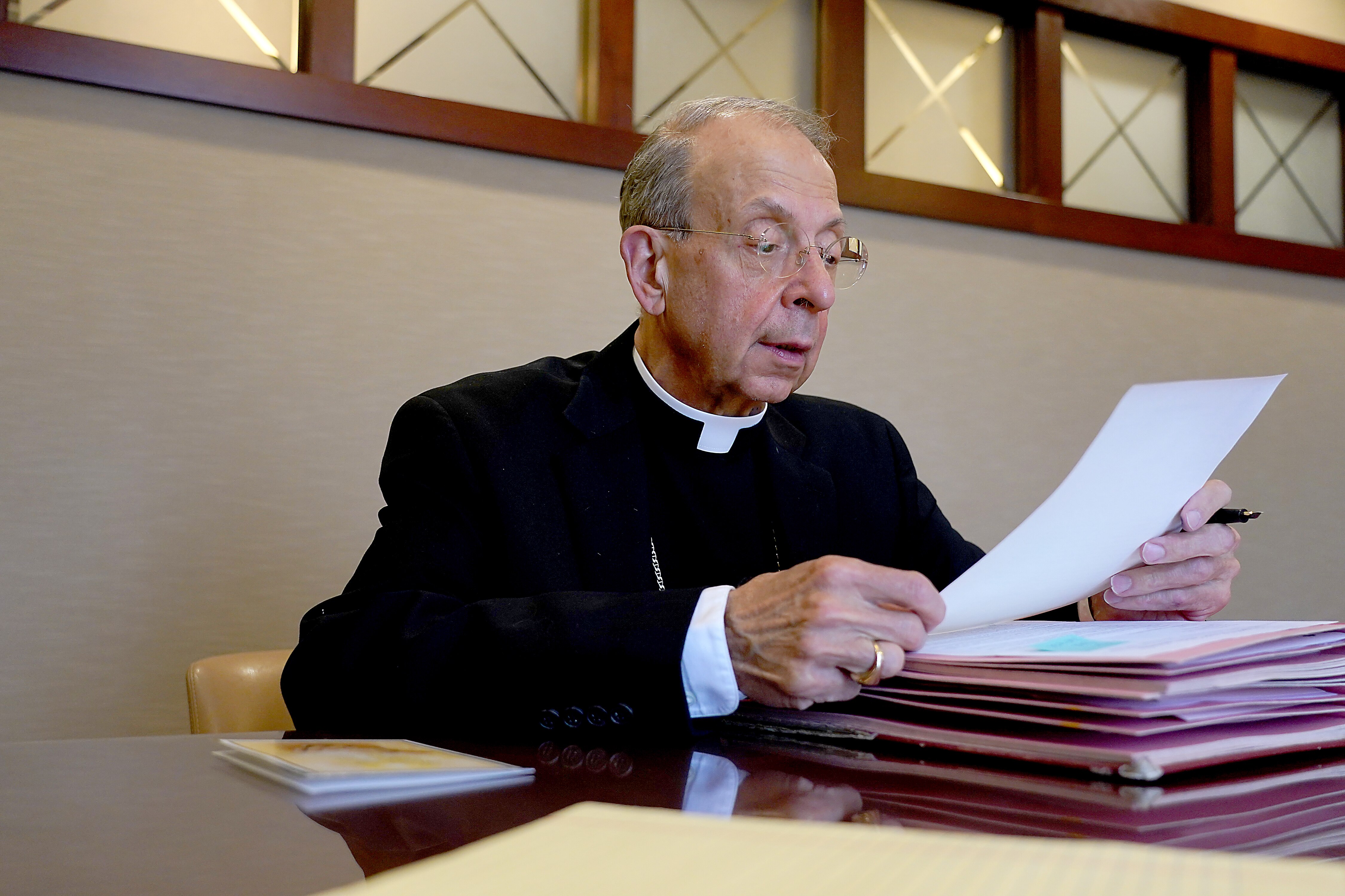 Archbishop William Lori of the Archdiocese of Baltimore reviews documents. The archdiocese announced it was filing for bankruptcy days ahead of a Maryland law taking effect that eliminated the statute of limitations for victims of sexual abuse to file a lawsuit against the church.