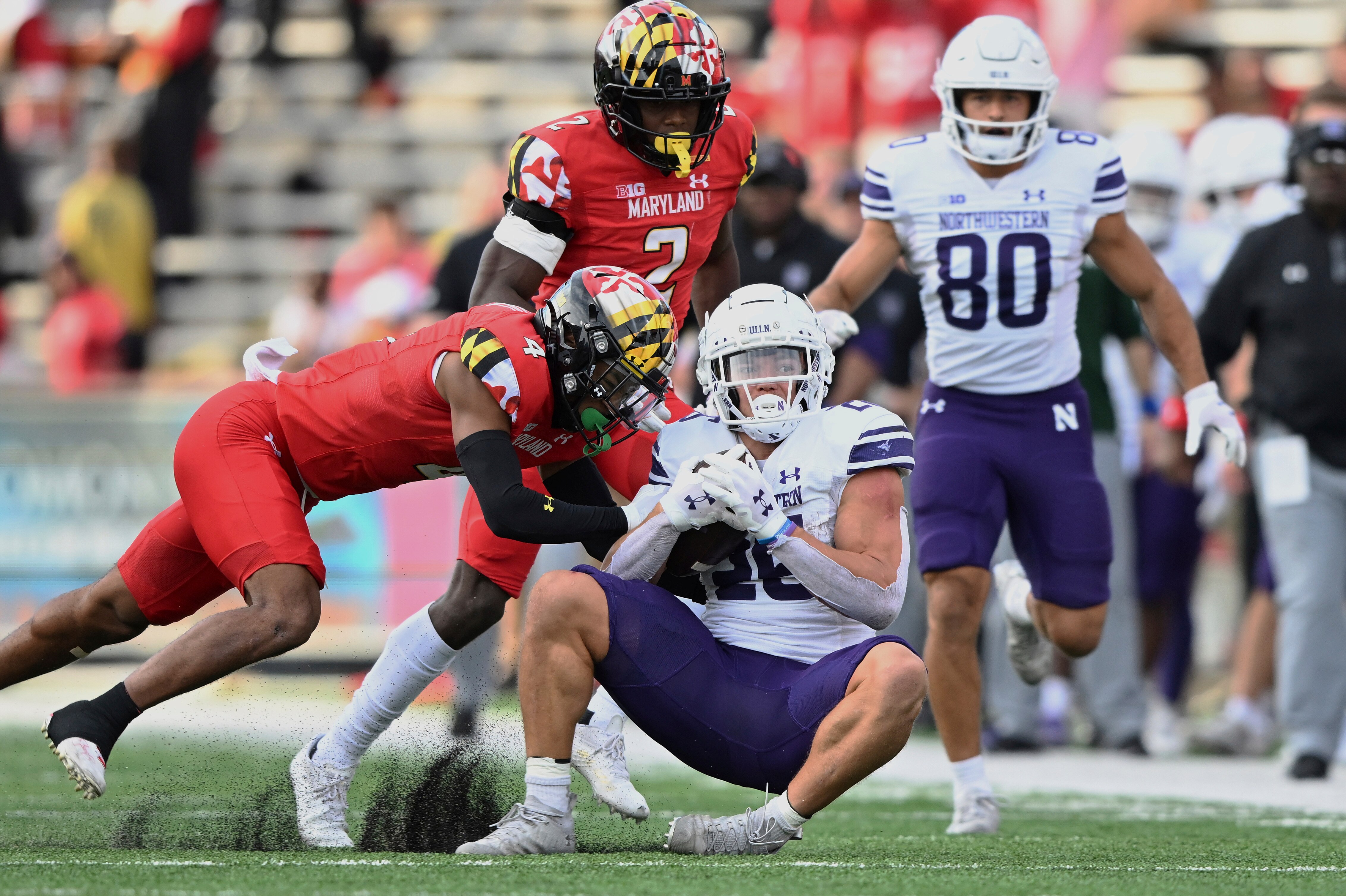 Northwestern running back Evan Hull is tackled by Maryland defensive back Tarheeb Still in the first half of an NCAA college football game, Saturday, Oct. 22, 2022, in College Park, Md.