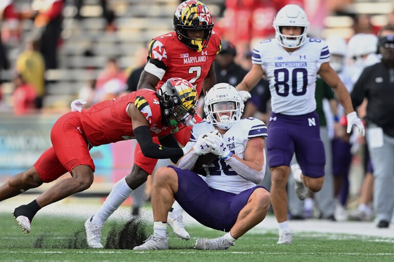 Northwestern running back Evan Hull is tackled by Maryland defensive back Tarheeb Still in the first half of an NCAA college football game, Saturday, Oct. 22, 2022, in College Park, Md.